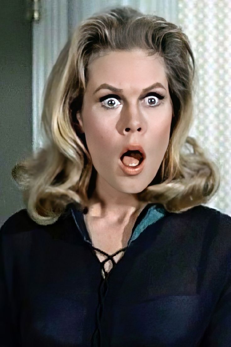 This may contain: a woman making a surprised face in a room